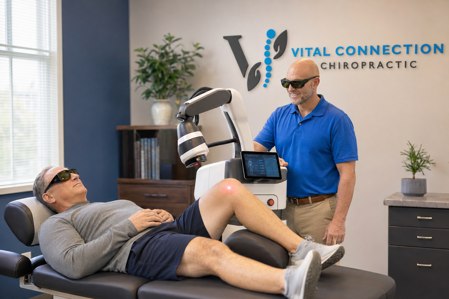 Doctor Jarred applying MLS laser therapy to a patient's shoulder in Fishers, IN, mls laser therapy, laser therapy near me, MLS laser therapy near me, laser therapy Fishers IN, M7 laser therapy,